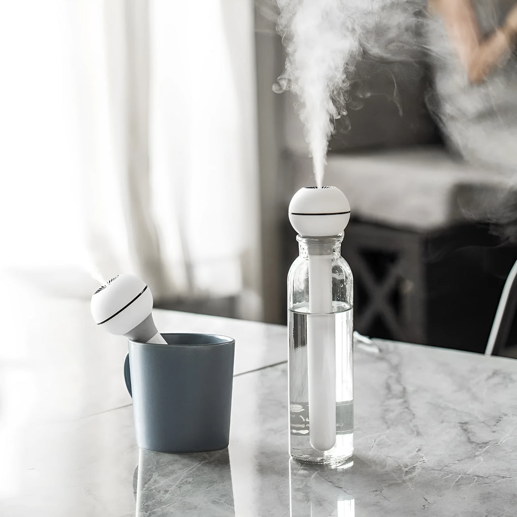 White columnar Magic Wand ultrasonic humidifier with USB cable and mist output.