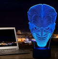 A clear acrylic 3D LED table lamp displaying gradient colours, standing on a square base with a USB cable and remote control.