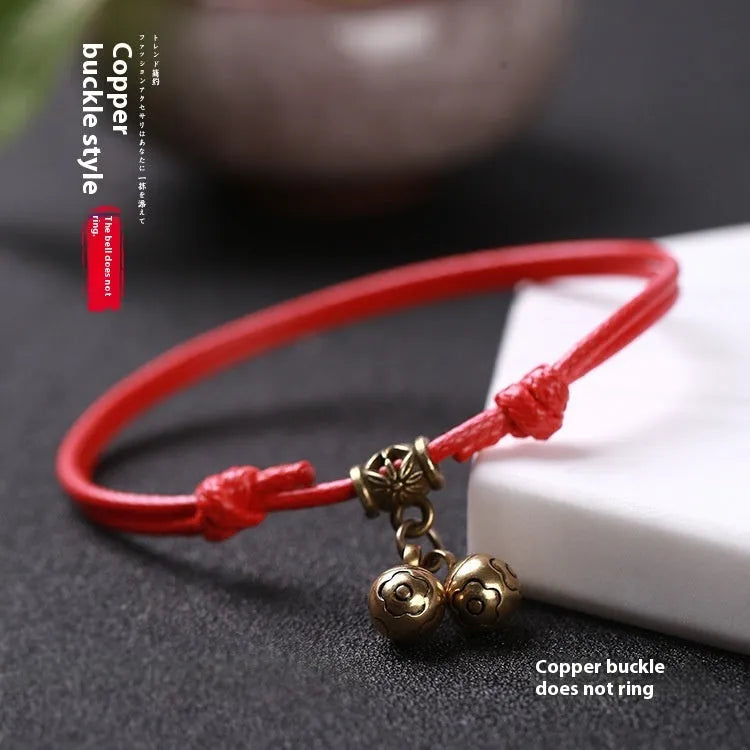 Small dog wearing adjustable nylon rope collar with brass bell in black, red or coffee colour