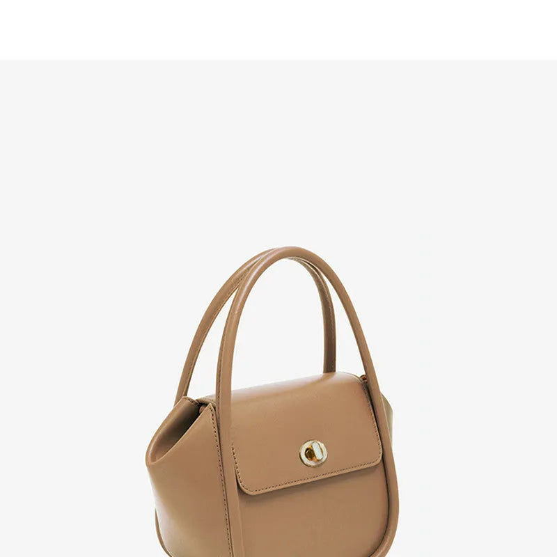 Soft cow leather wing-shaped tote handbag with a buckle and cross-body strap in four colour options.