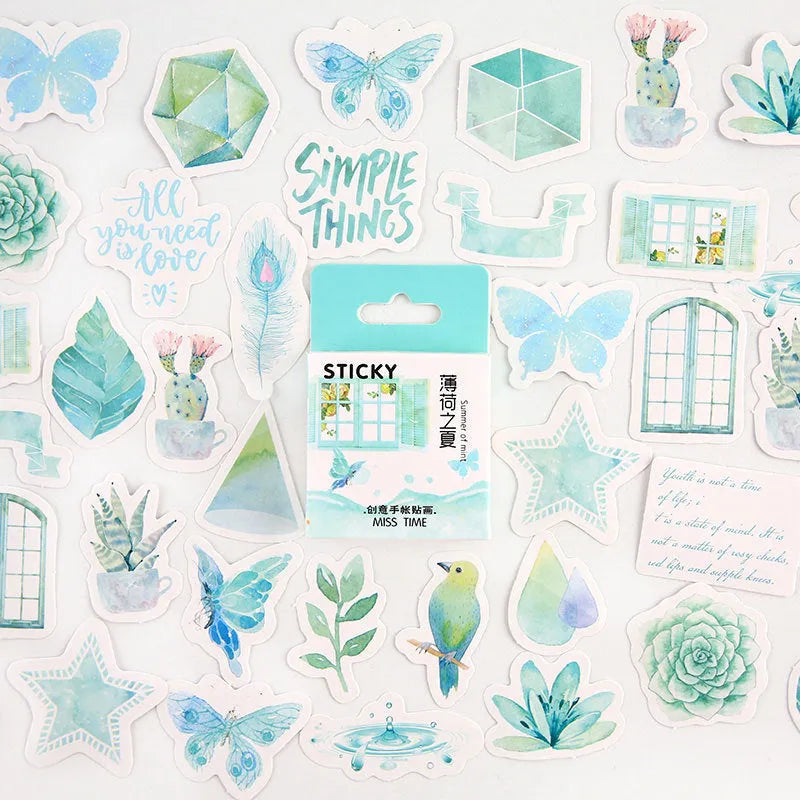 Open box showing 46 small cartoon pattern stickers for journal decoration, themes include Girlhood and Bubble Comic.