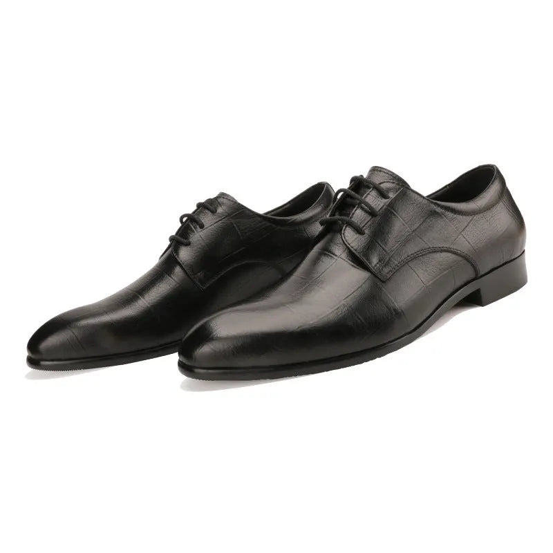 Men's black leather derby shoes with pointed toe and checkered pattern on a white background.