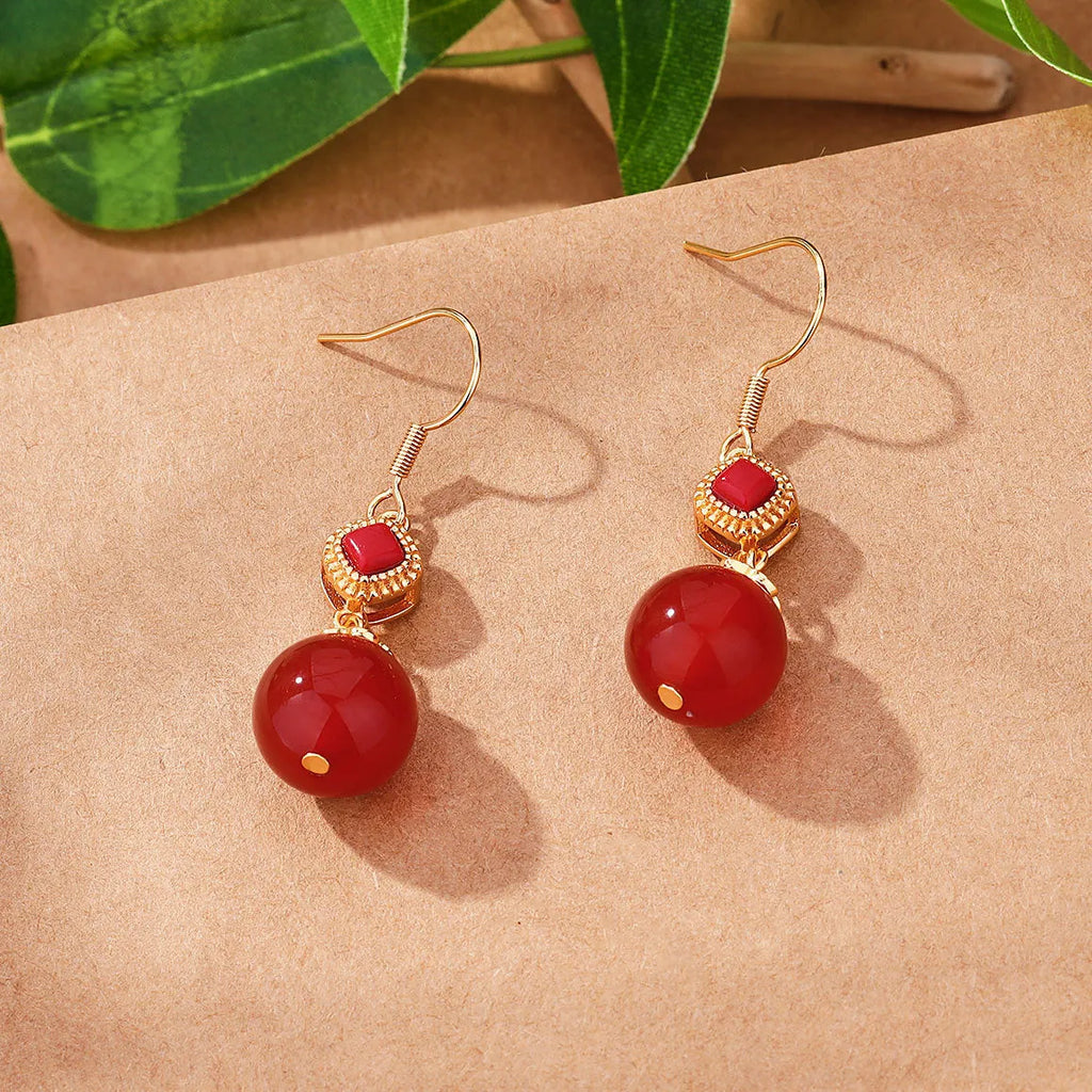 Geometric copper earrings with red agate beads and electroplated silver detailing