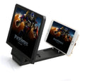 Black foldable mobile phone stand with an attached 3D screen amplifier, holding a smartphone.