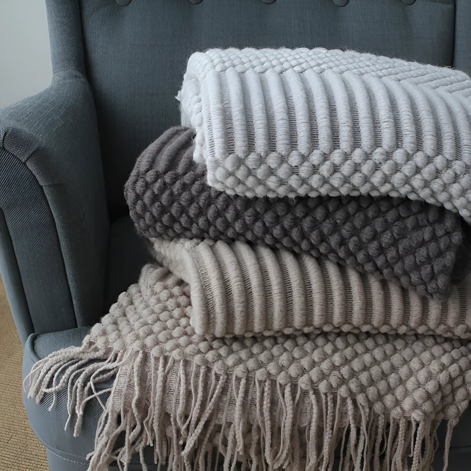 Small polyester fibre nap blanket measuring 127cm by 170cm in dark grey colour