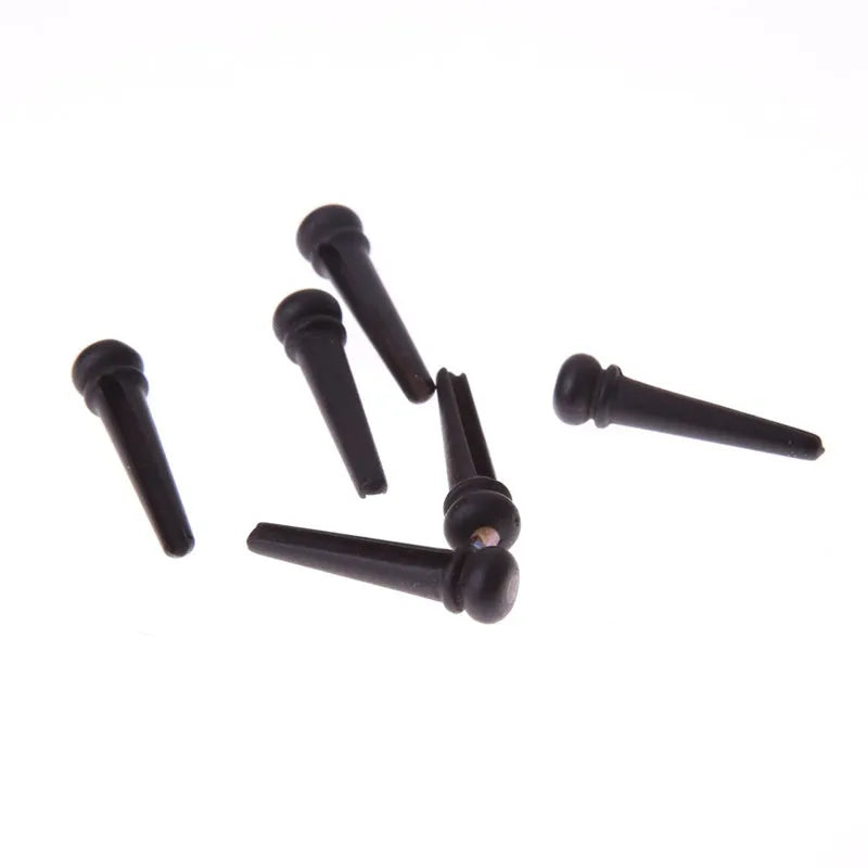 Six ebony folk guitar string nails with matt black finish for acoustic guitar bridge