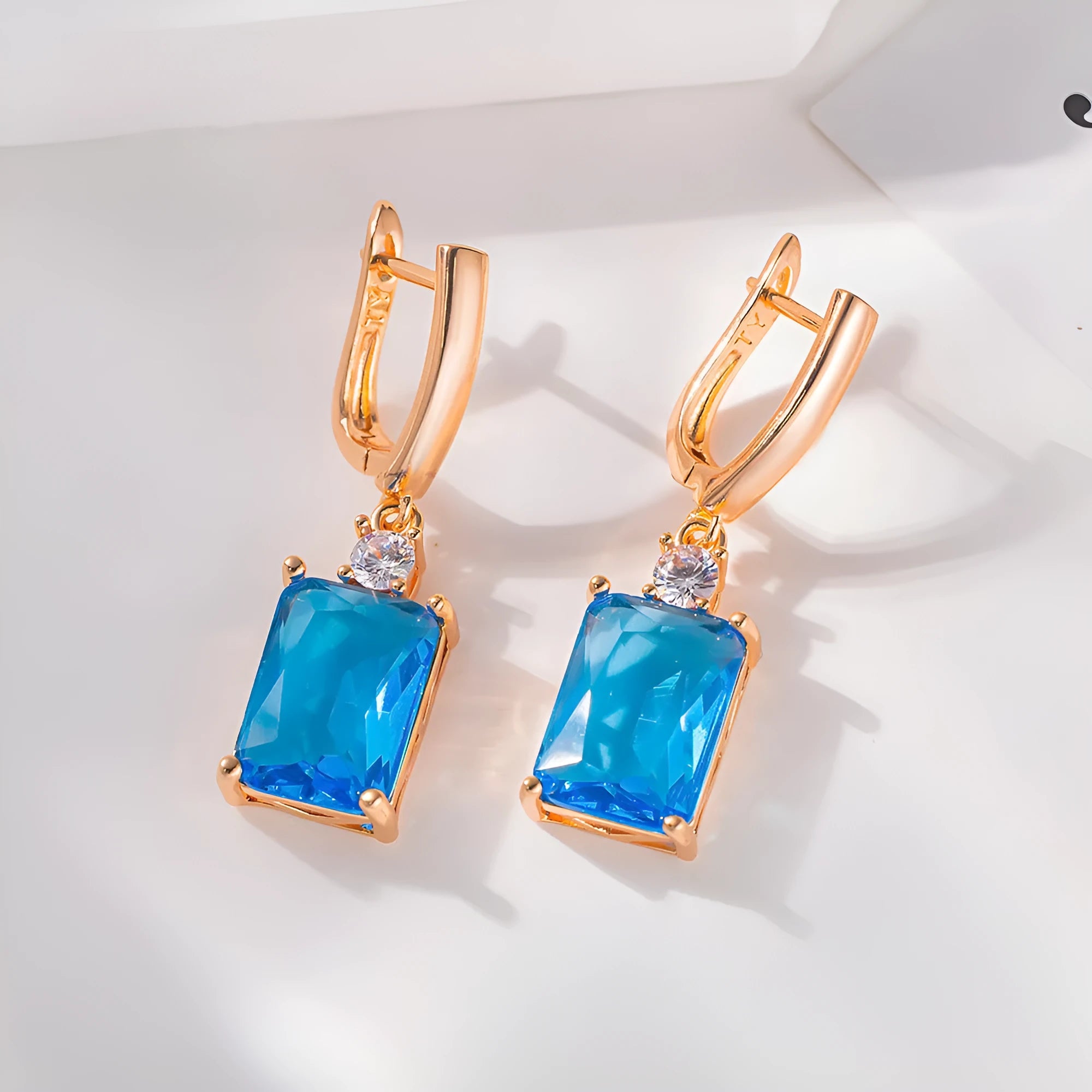 Square geometric copper earrings with gold or silver electroplated finish showing quadrilateral shape.