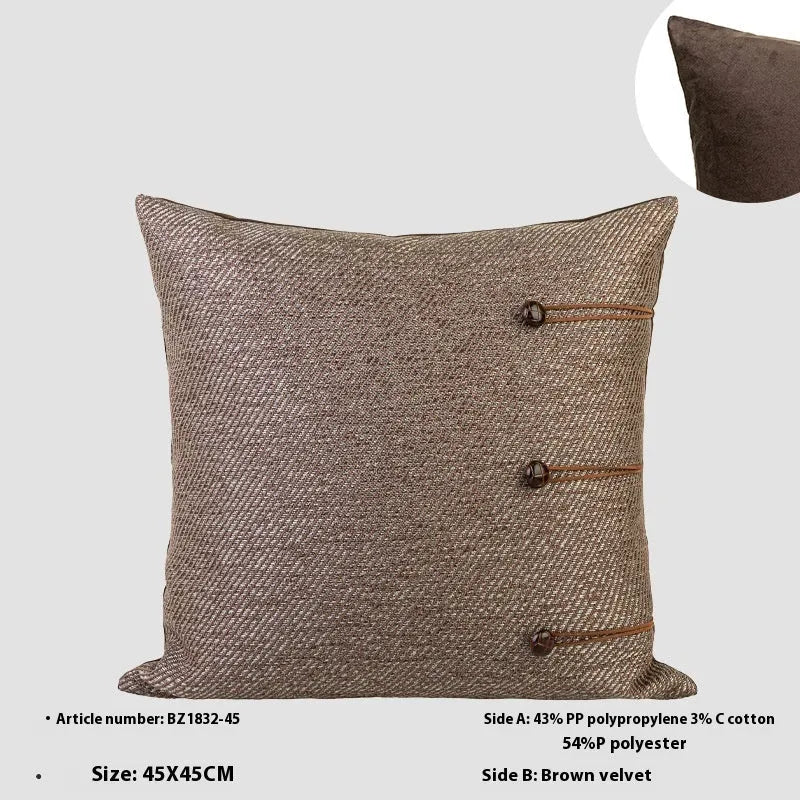 Square Chinese ancient style decorative cushion with a geometric pattern in a brown Maillard colour on a grey sofa.