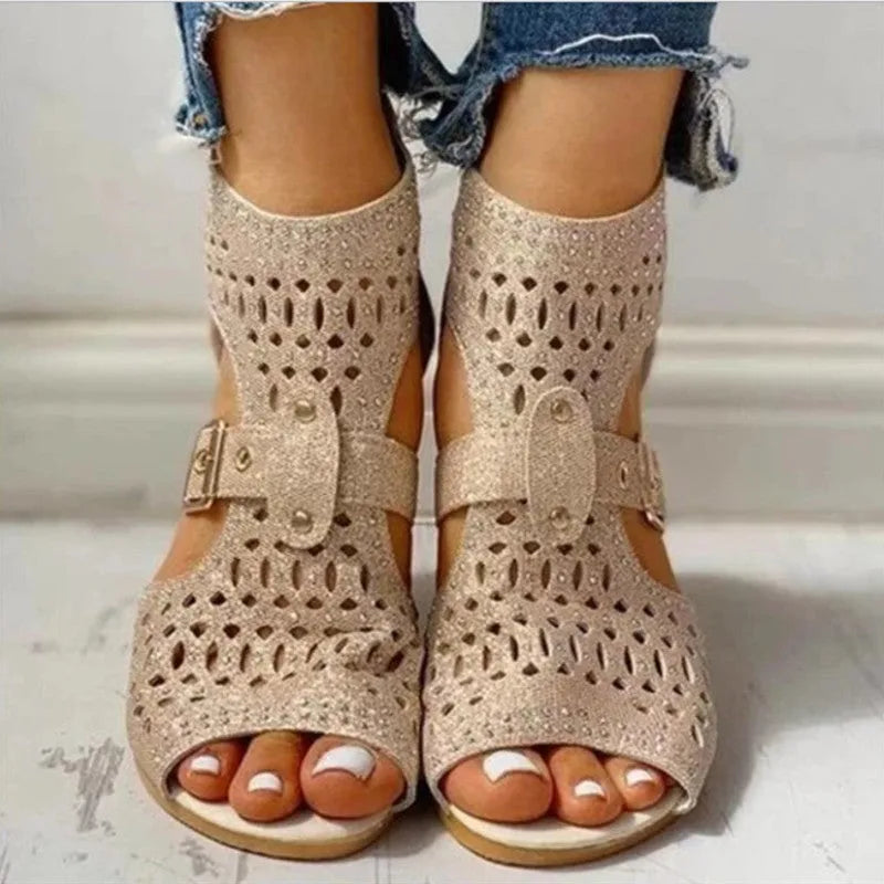 Women's beige rivet flat sandals with a back zipper, fish mouth toe, and a low wedge heel.