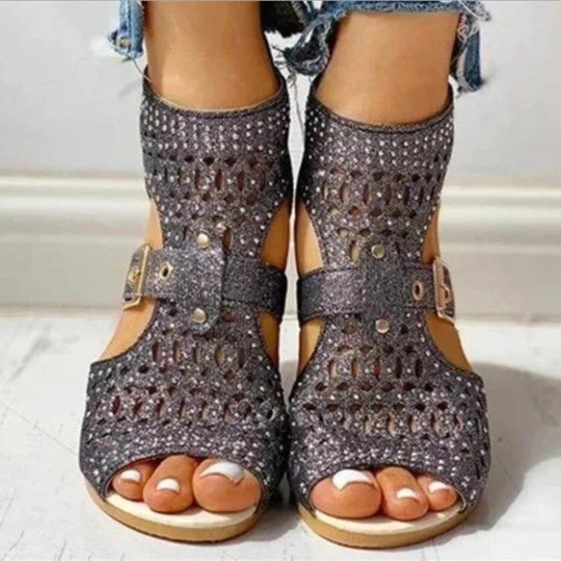 Women's beige rivet flat sandals with a back zipper, fish mouth toe, and a low wedge heel.