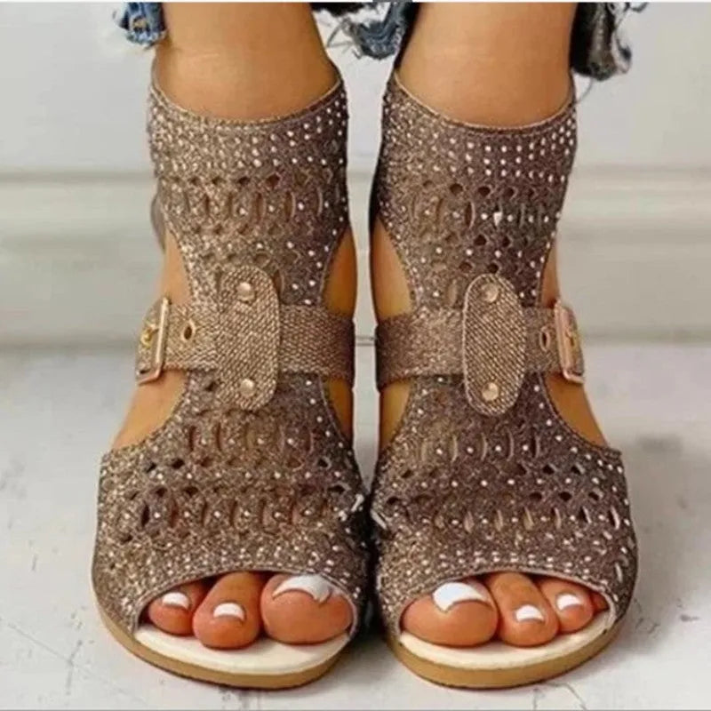 Women's beige rivet flat sandals with a back zipper, fish mouth toe, and a low wedge heel.