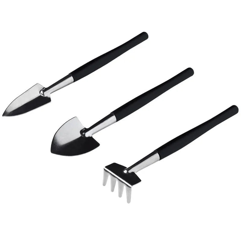 Black mini garden hand tools set for succulent plants, showing scissors, tweezers, watering bottle, shovel, and cushion.