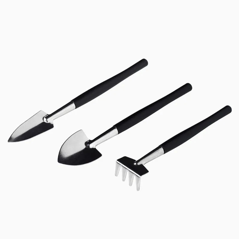 Black mini garden hand tools set for succulent plants, showing scissors, tweezers, watering bottle, shovel, and cushion.