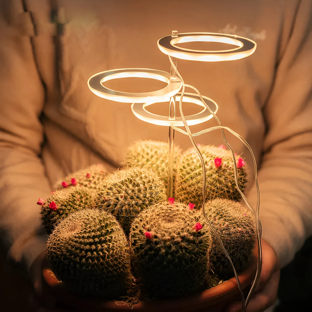 USB-powered LED plant grow light with full spectrum yellow LEDs, acrylic mounting stick, in pink/white colour.