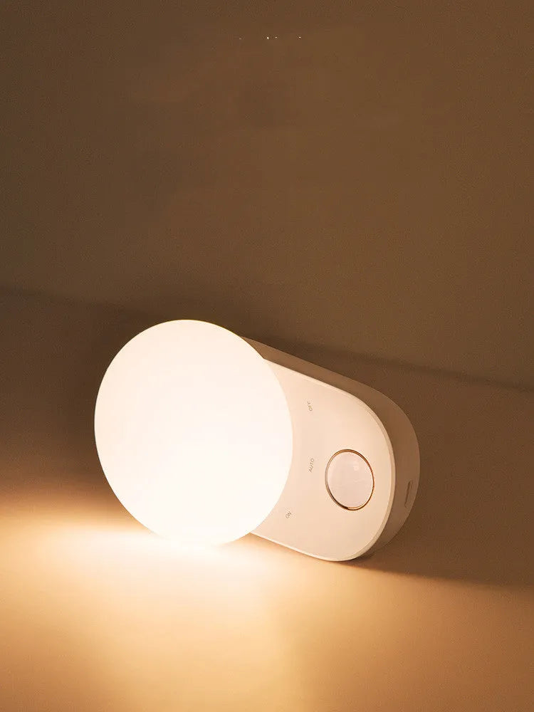 White Baseus rechargeable sensor night light with motion detection and warm LED glow.