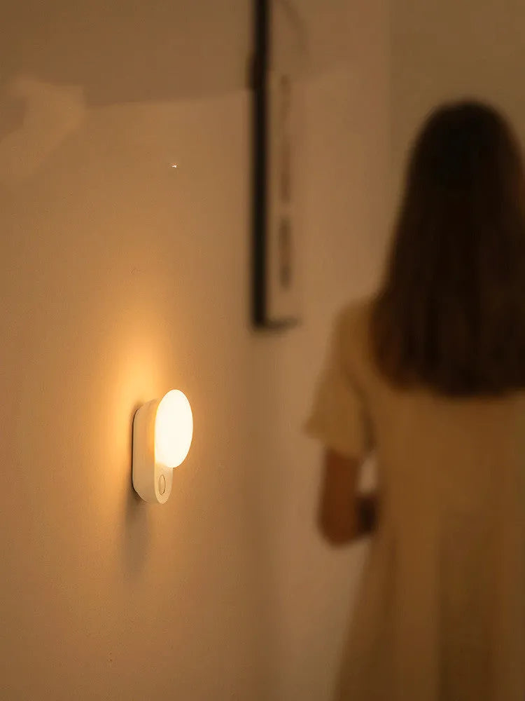 White Baseus rechargeable sensor night light with motion detection and warm LED glow.