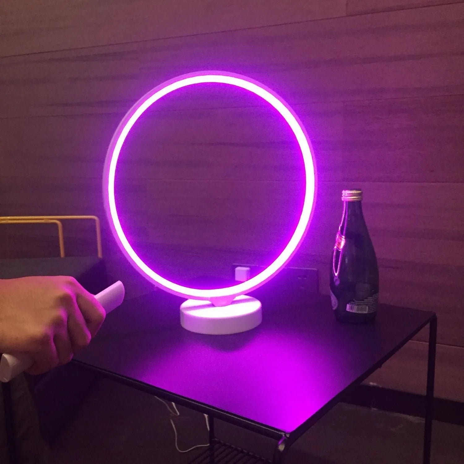 White Full Moon shaped table lamp with LED lighting and a remote control on a table.
