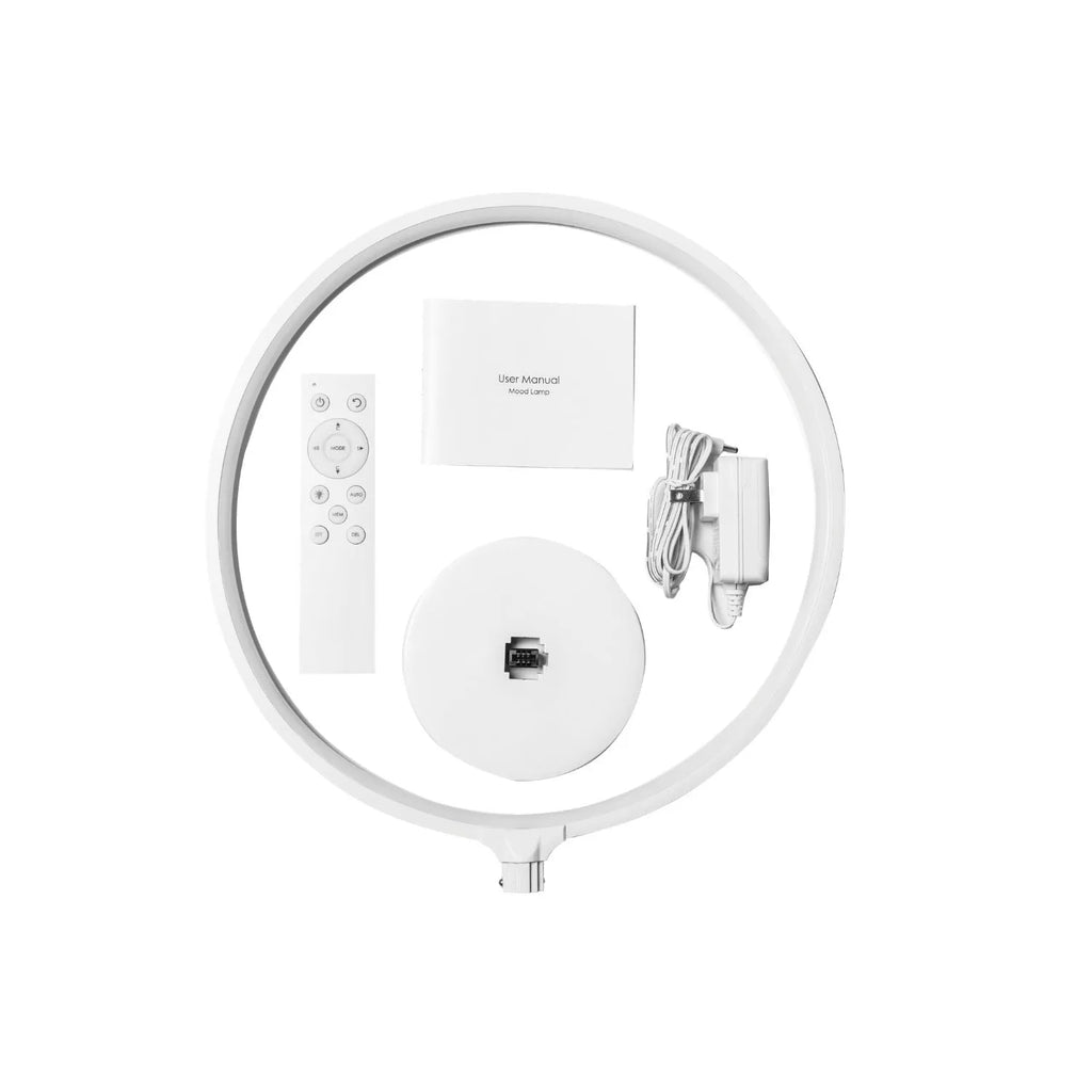 White Full Moon shaped table lamp with LED lighting and a remote control on a table.