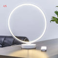 White Full Moon shaped table lamp with LED lighting and a remote control on a table.