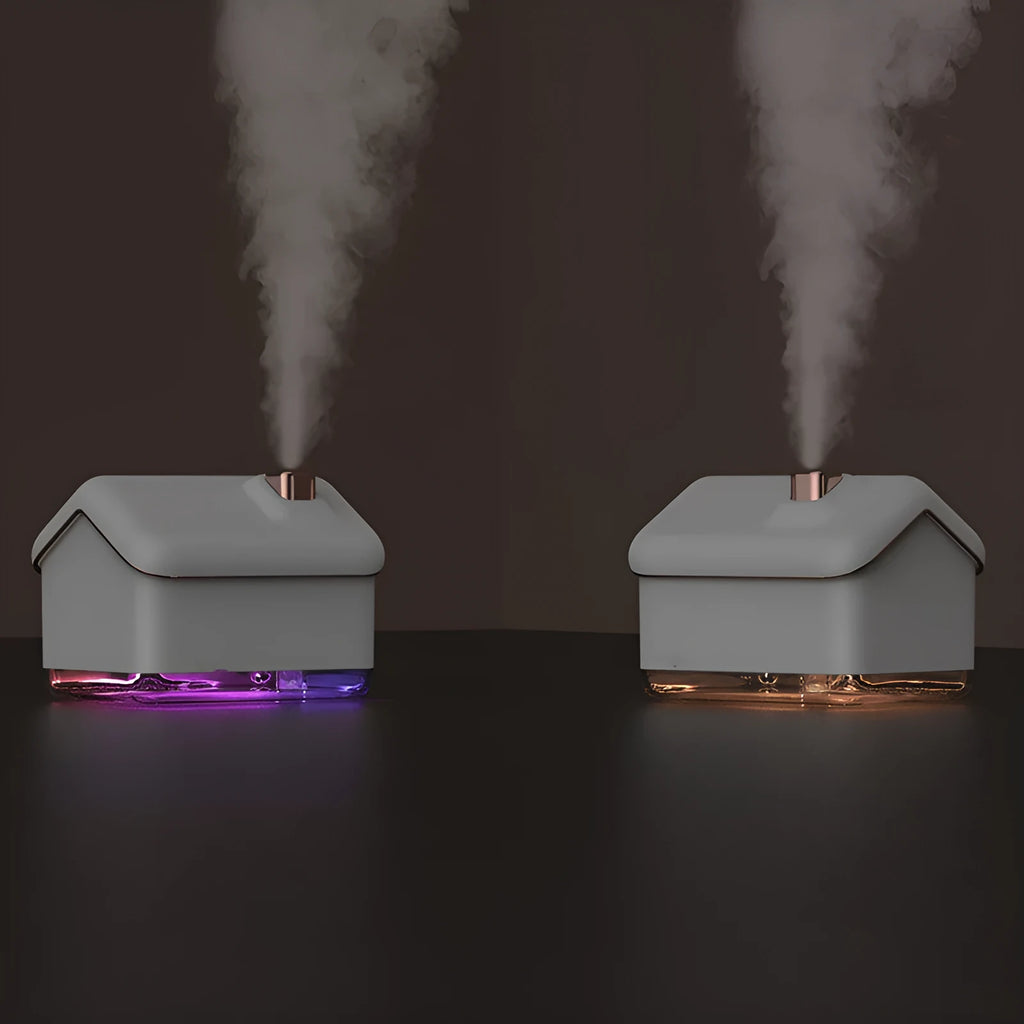 White ultrasonic humidifier and essential oil diffuser with LED light showing mist output