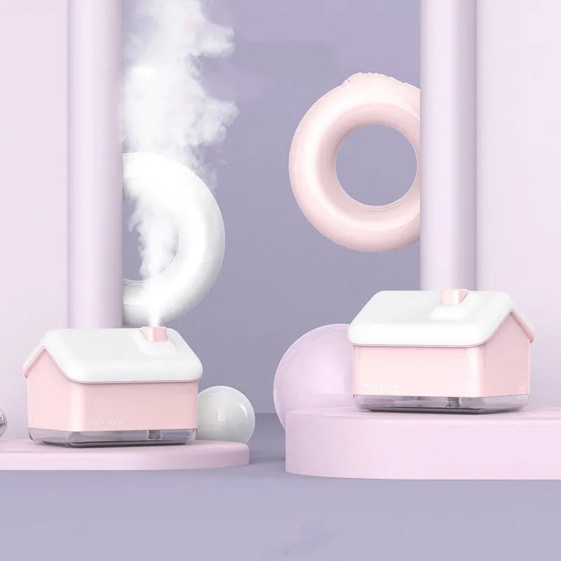 White ultrasonic humidifier and essential oil diffuser with LED light showing mist output