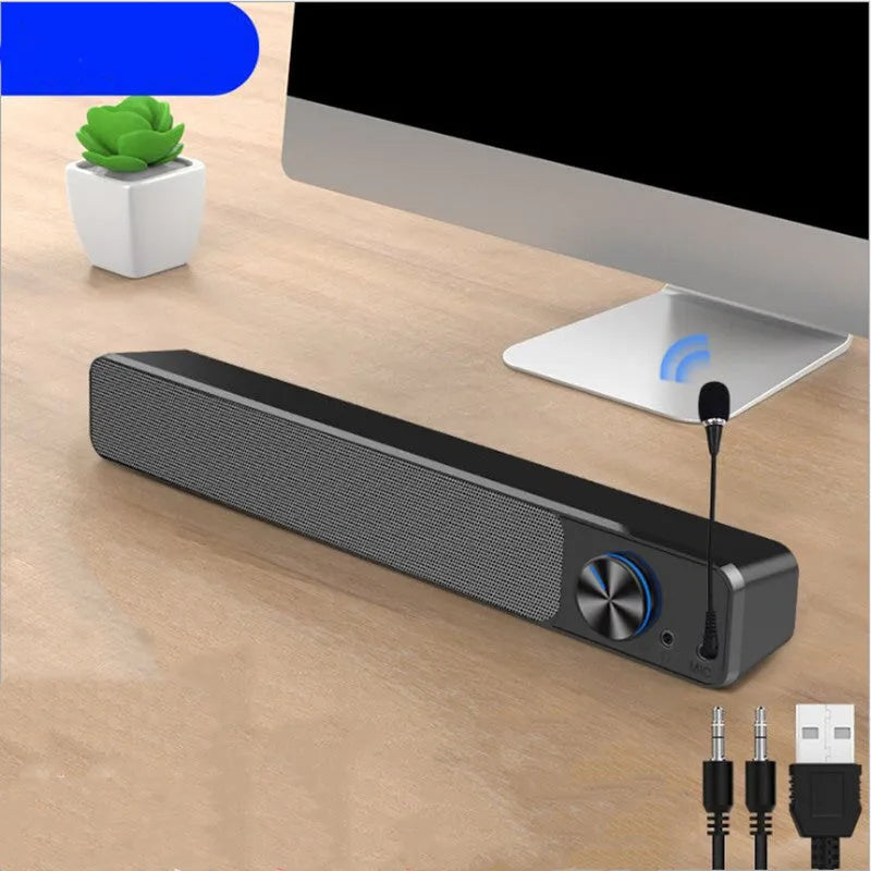 Black and white desktop computer speaker with 2.0 channel audio on wooden desk