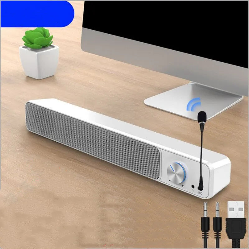 Black and white desktop computer speaker with 2.0 channel audio on wooden desk