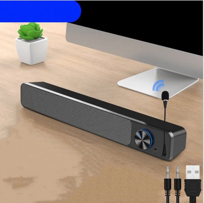 Black and white desktop computer speaker with 2.0 channel audio on wooden desk