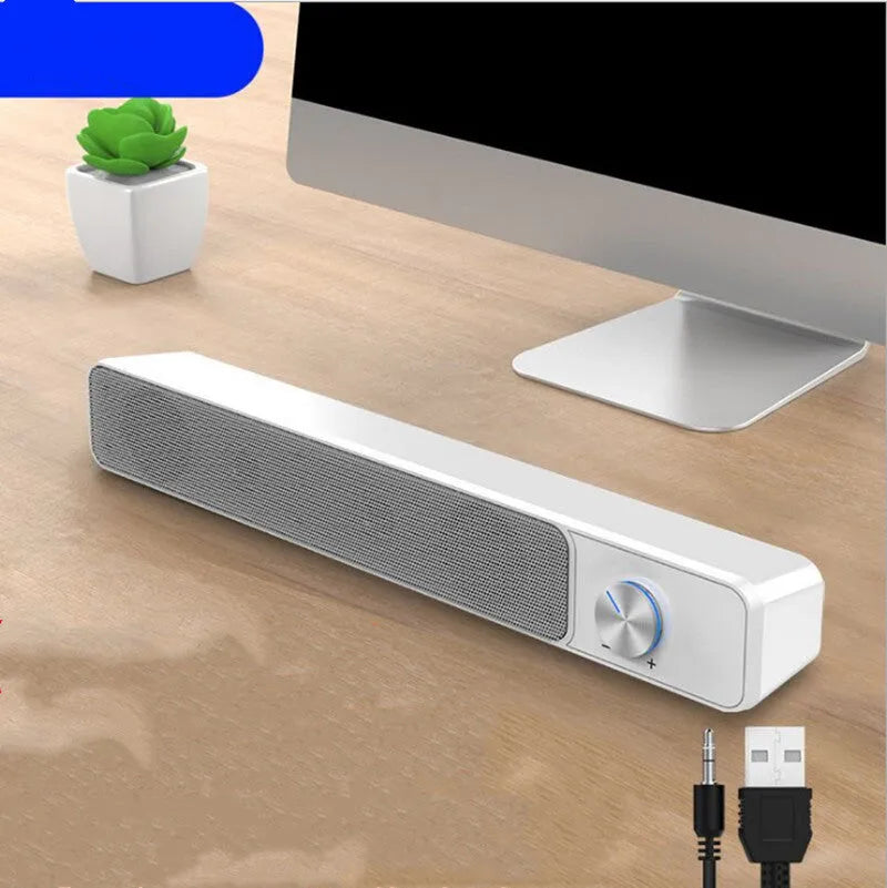 Black and white desktop computer speaker with 2.0 channel audio on wooden desk
