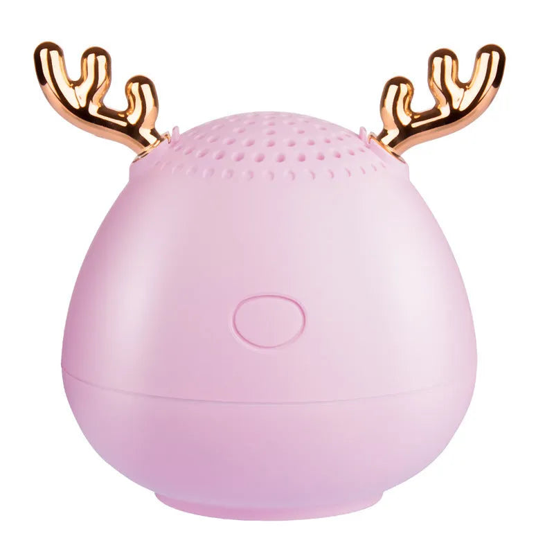 Compact Bluetooth wireless speaker in green colour with USB charging cable