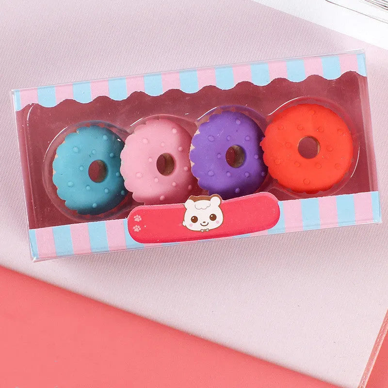 Set of 12 colourful cartoon food erasers including ice creams, donuts, lollipops, and cones.