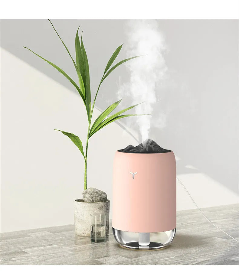 White Magic Flame ultrasonic humidifier and aroma diffuser on a wooden desk.