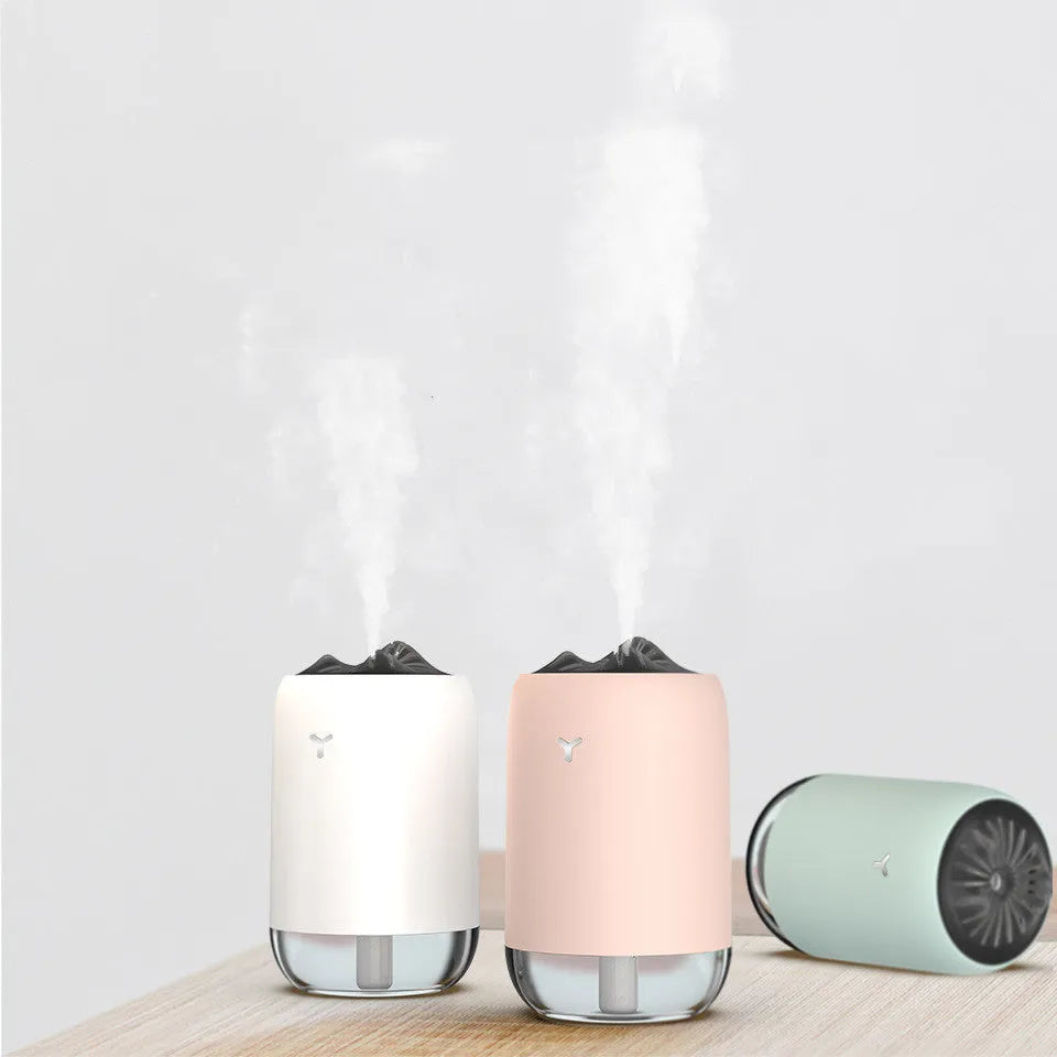 White Magic Flame ultrasonic humidifier and aroma diffuser on a wooden desk.