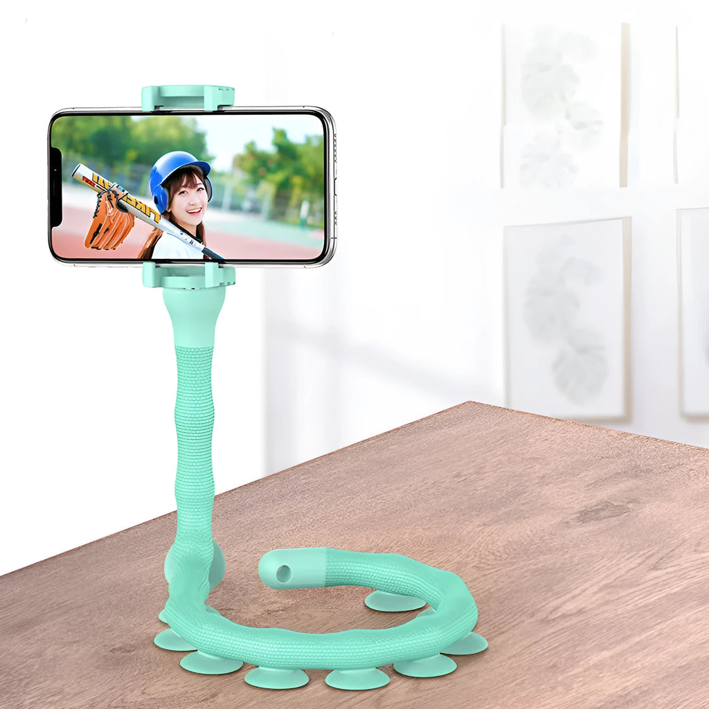 Flexible rubber phone holder with suction cup mounted on desktop showing 360-degree rotation