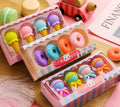 Set of 12 colourful cartoon food erasers including ice creams, donuts, lollipops, and cones.