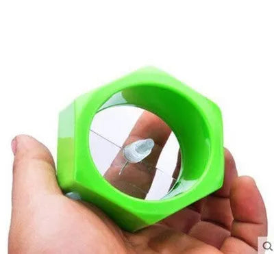 Yellow and green kitchen vegetable cutter with spiral knife mechanism for slicing cucumbers
