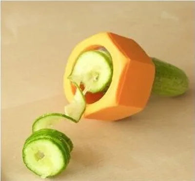 Yellow and green kitchen vegetable cutter with spiral knife mechanism for slicing cucumbers