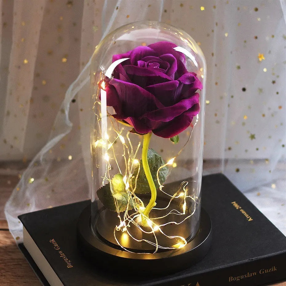 LED rose ornament with silk flowers under glass shade, showing colour options on a wooden base.