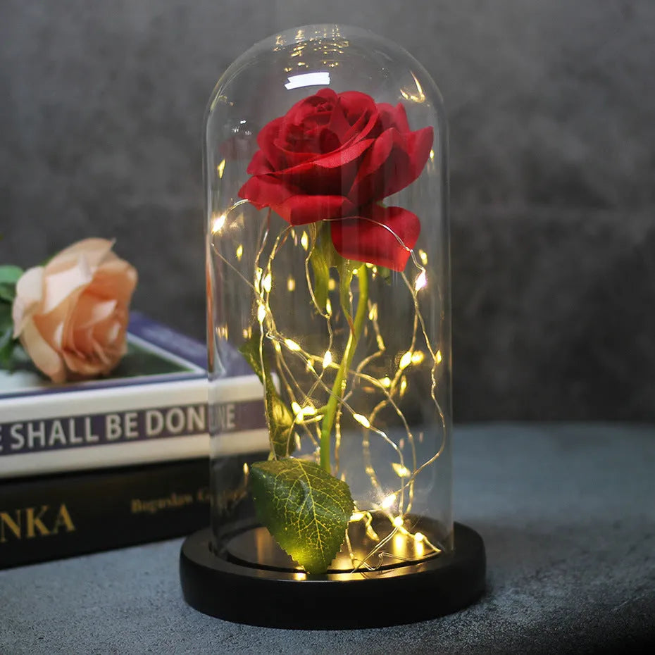 LED rose ornament with silk flowers under glass shade, showing colour options on a wooden base.