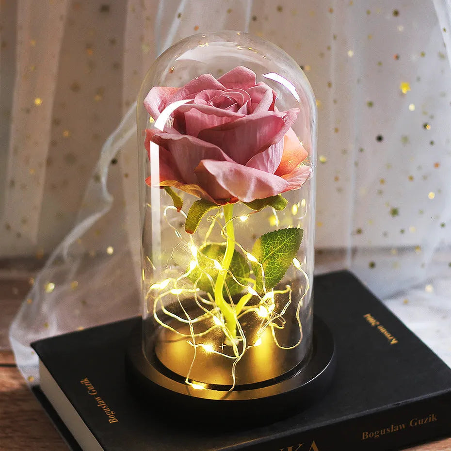 LED rose ornament with silk flowers under glass shade, showing colour options on a wooden base.