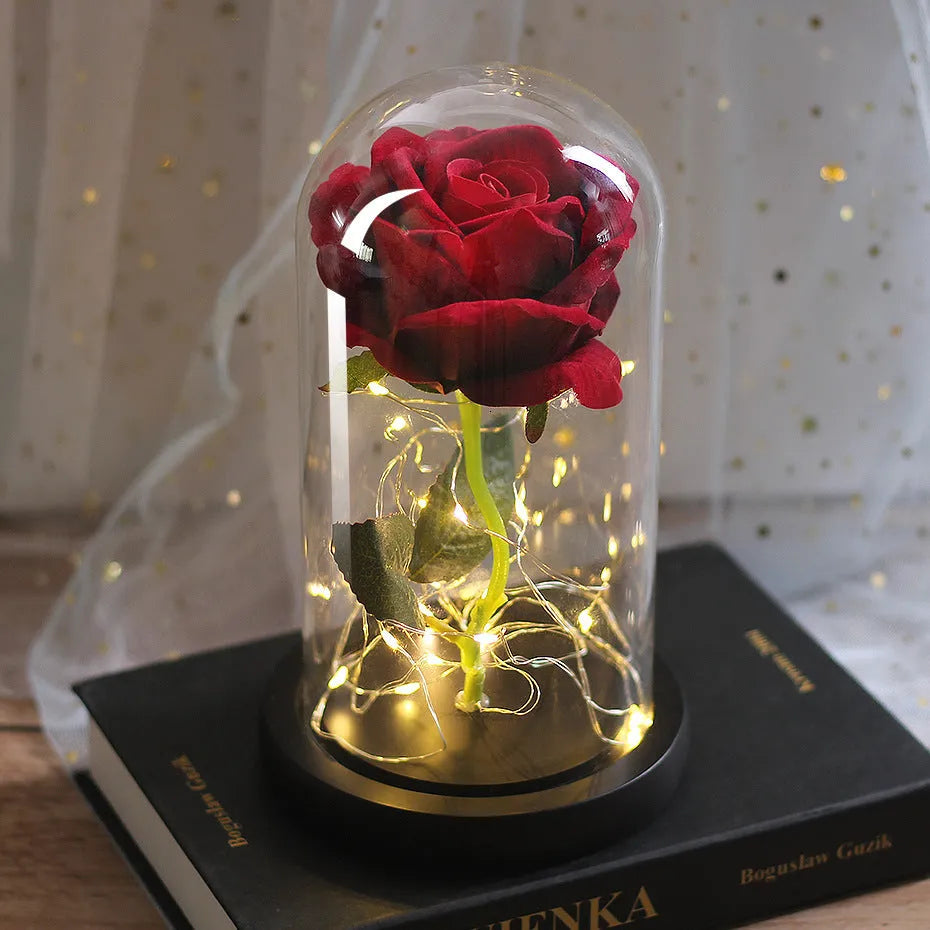 LED rose ornament with silk flowers under glass shade, showing colour options on a wooden base.