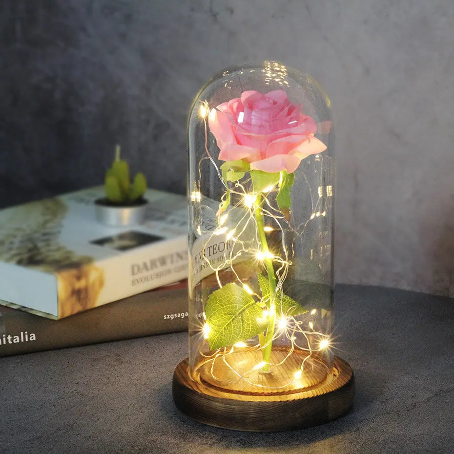 LED rose ornament with silk flowers under glass shade, showing colour options on a wooden base.
