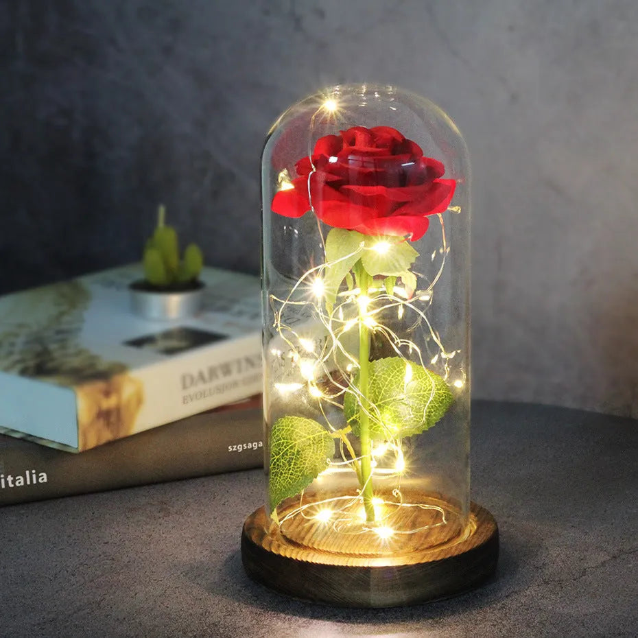 LED rose ornament with silk flowers under glass shade, showing colour options on a wooden base.