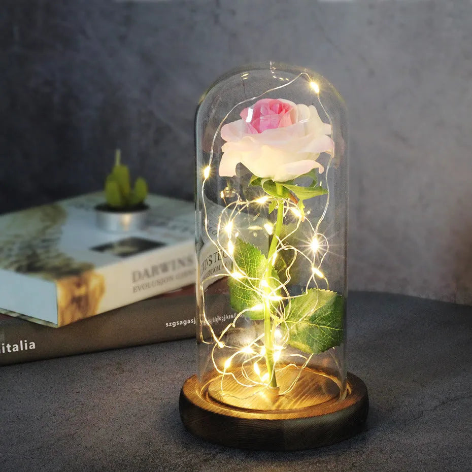 LED rose ornament with silk flowers under glass shade, showing colour options on a wooden base.