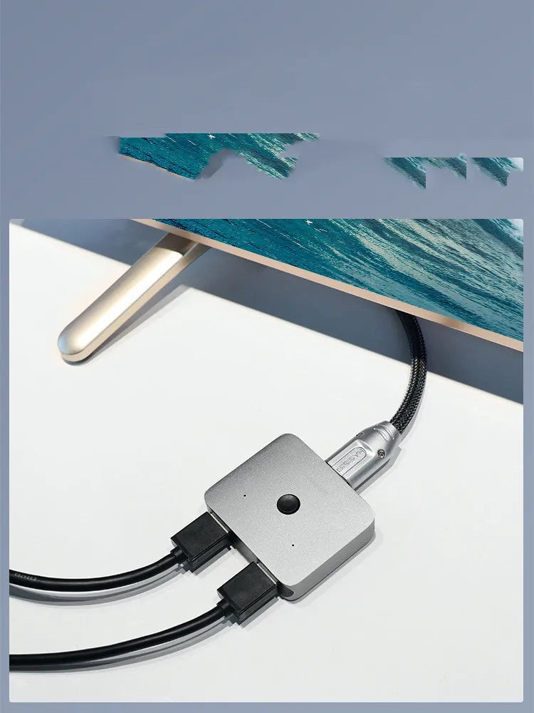 Gray Haibeisi HDMI switcher unit showing one input and two output ports for splitting a video signal.