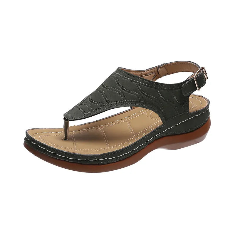 Women's black casual wedge heel flip flop sandals showing adjustable back buckle strap and solid colour design.