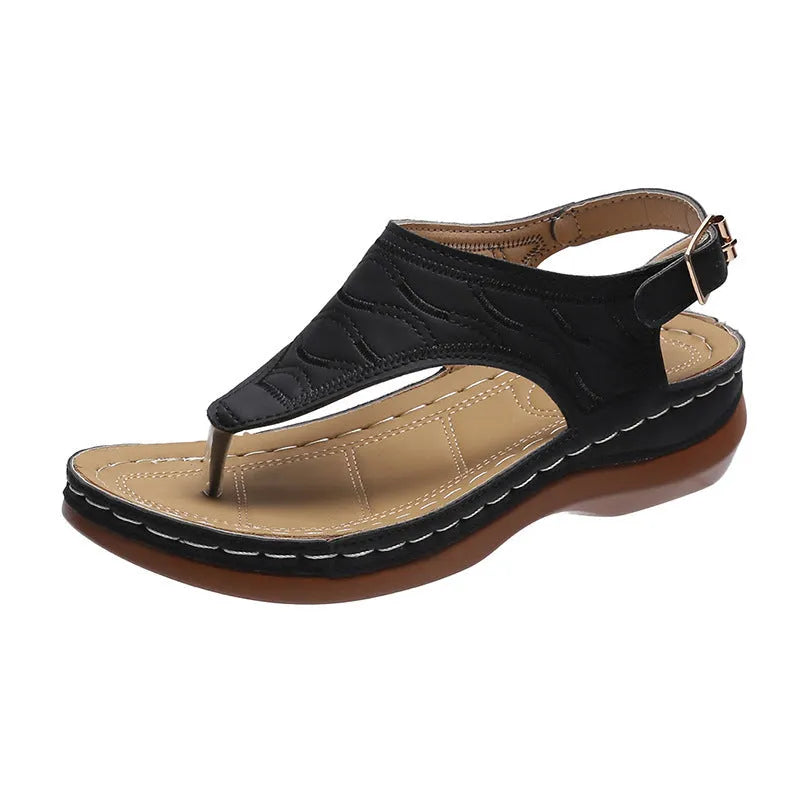 Women's black casual wedge heel flip flop sandals showing adjustable back buckle strap and solid colour design.