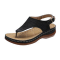 Women's black casual wedge heel flip flop sandals showing adjustable back buckle strap and solid colour design.