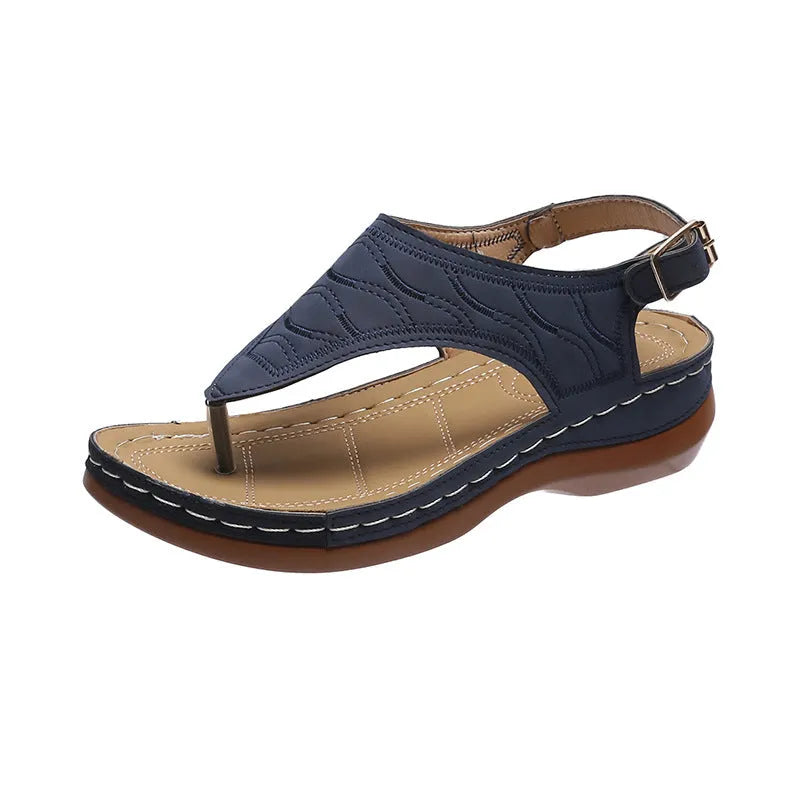 Women's black casual wedge heel flip flop sandals showing adjustable back buckle strap and solid colour design.