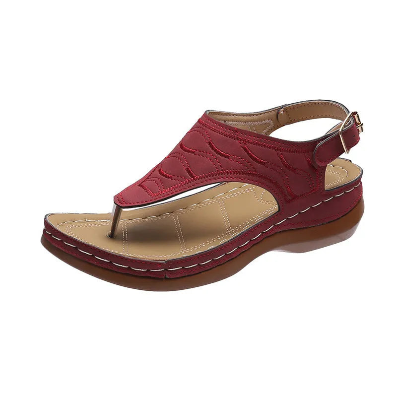 Women's black casual wedge heel flip flop sandals showing adjustable back buckle strap and solid colour design.